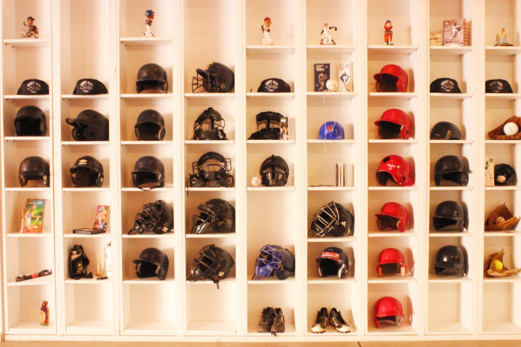 Baseball helmets on shelves.