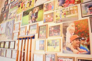 Bats and baseball photos on a wall.