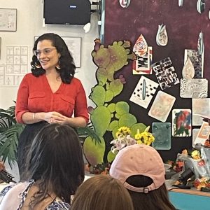 Catalina Nino Cordero (G'22) speaks to a crowd at La Casita